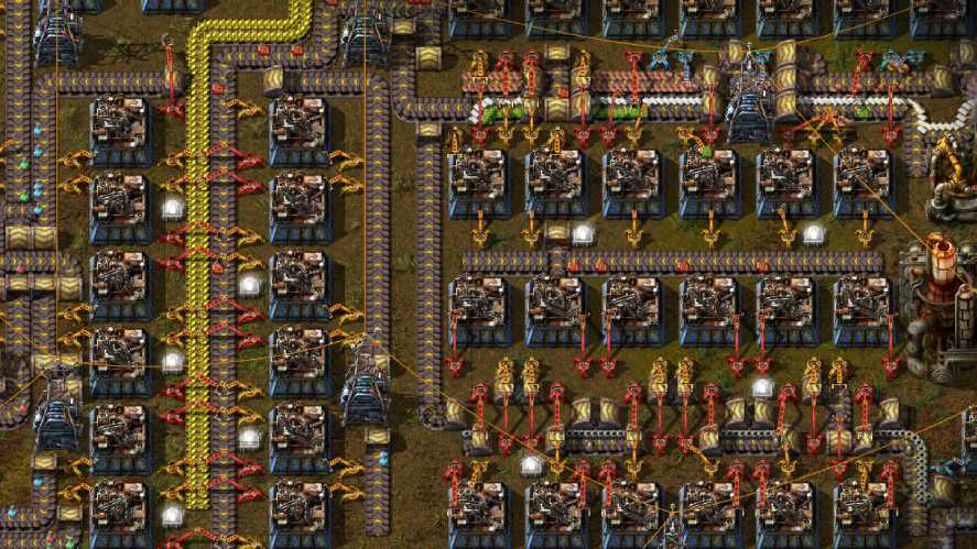 An overhead, top-down factory management screenshot from Factorio, showcasing an intricate network of blue assembling machines, yellow and red inserters, yellow transport belts carrying items, and power poles organizing a complex automated production line.